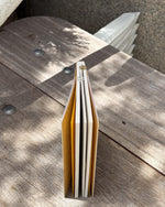 Open book on a wooden surface with sunlight casting shadows