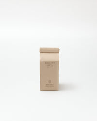 Beige soap bag with branding on a white background