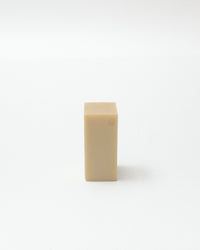 Beige rectangular bar of soap on a white background