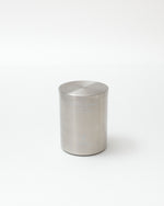 Silver cylindrical container on a white background