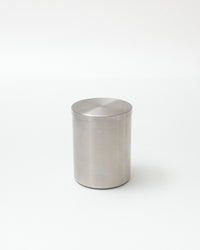 Silver cylindrical container on a white background