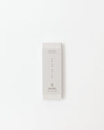 Rectangular white product packaging with text on a light gray background