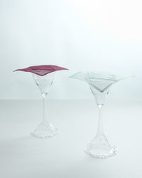 Two clear martini glasses on a white background