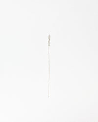 A delicate silver wheat stalk pin with a textured, bead-like head and a long, slender stem, shown on a plain white background.
