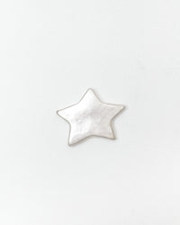 A small, five-pointed star-shaped ceramic with a textured, metallic silver finish, centered on a plain white background.