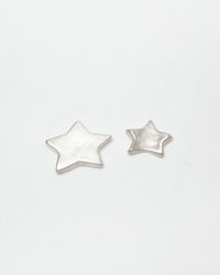 A pair of textured silver star-shaped ceramic items on a clean white background.
