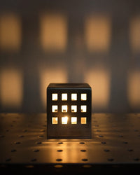 Decorative light fixture casting shadows on a textured wall