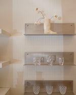 Shelves with decorative items against a neutral wall