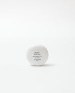 White skincare product container with text on a white background