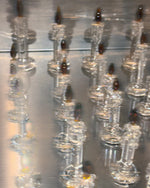 Clear glass candles on a reflective surface