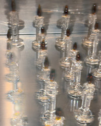 Clear glass candles on a reflective surface